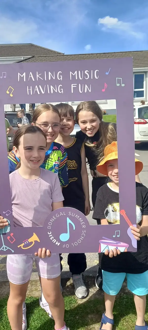 Students outdoors with a prop frame